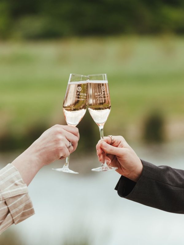A couple toast glasses at Balfour-winery